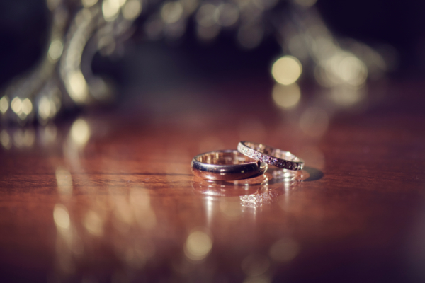 A pair of wedding rings resting on wood.