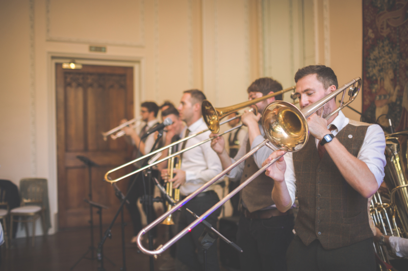 A trombonist plays as part of a brass band