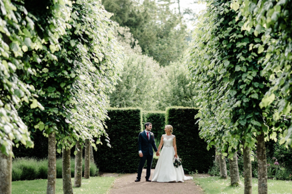 Wedding couple in avenue of trees