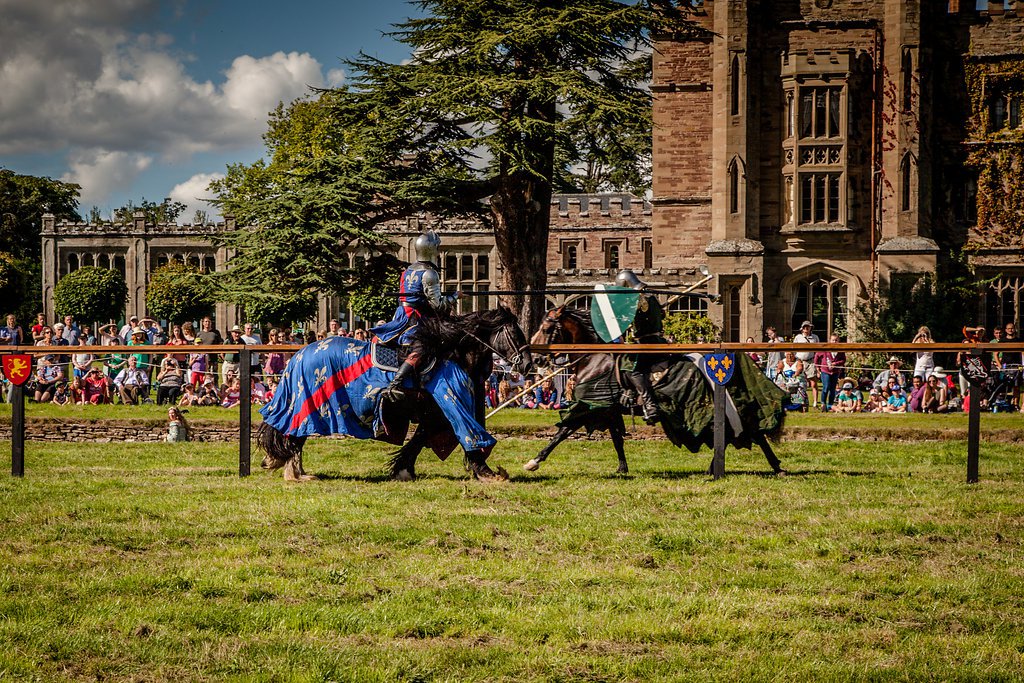 Two knights jousting in front of an audience