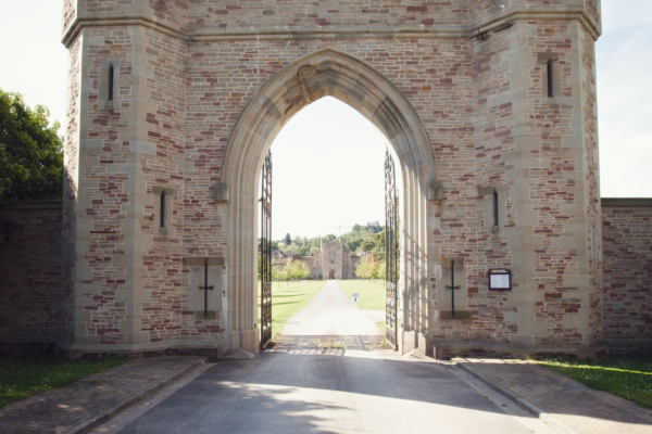 A gateway with a drive leading straight down to a castle
