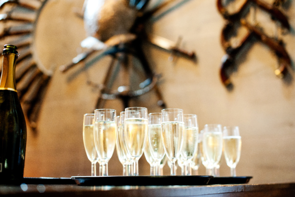 A tray full of champagne flutes, full of fizz
