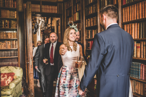 Wedding guests gathering in a library