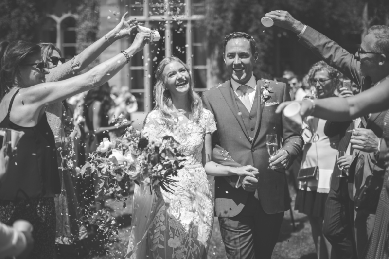 Black and white image of wedding couple and confetti