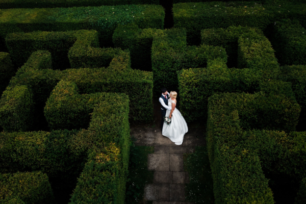 Wedding couple standing in Maze in gardens