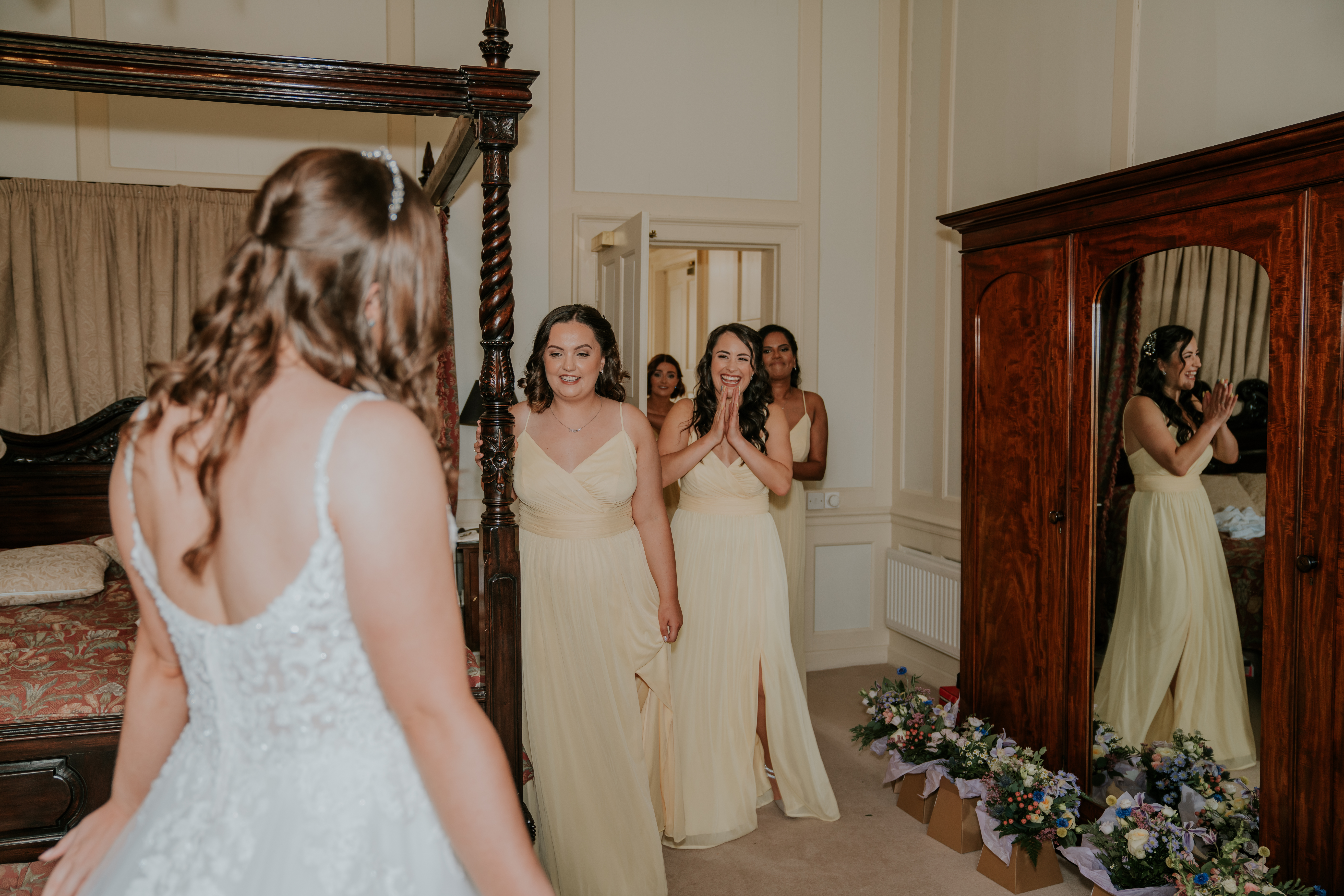 Bridesmaids see the bride in dress for first time
