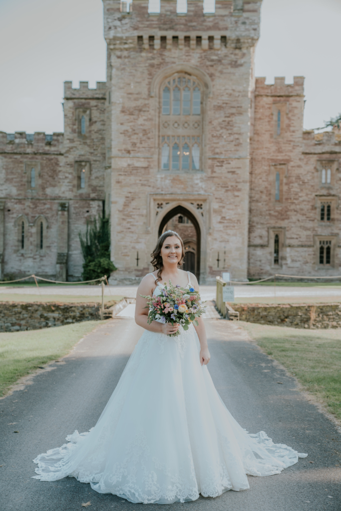 Bride stood on main drive in front of Castle