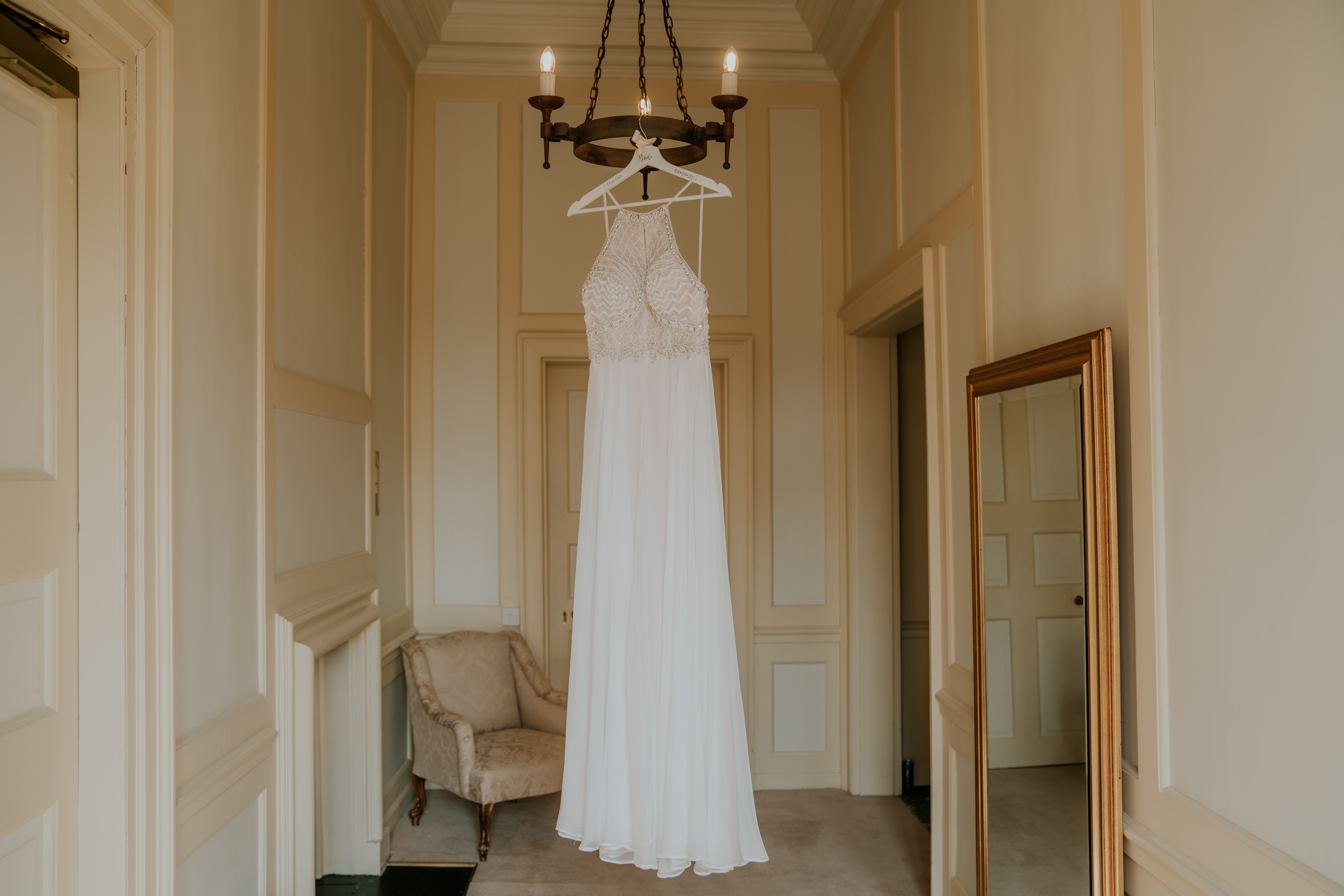 Second wedding dress hanging from light fitting