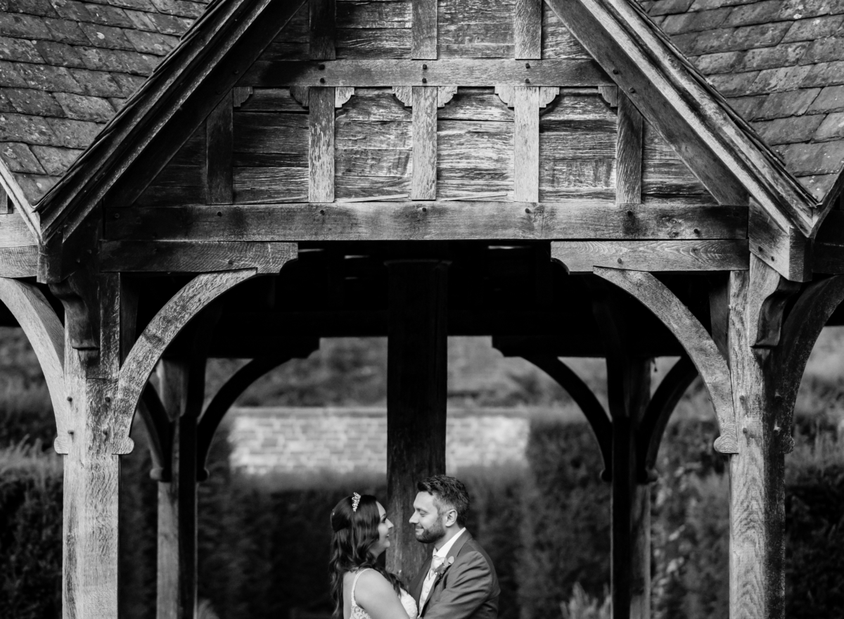 Couple embrace on the pavilion in black and white