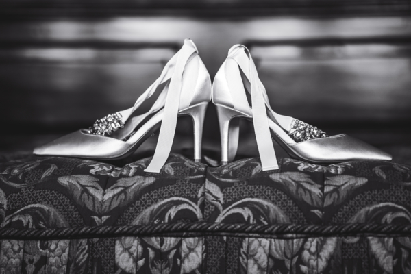 Black and white photo of bride's shoes