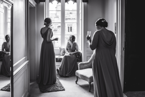 Bridesmaids have a drink whilst waiting for bride
