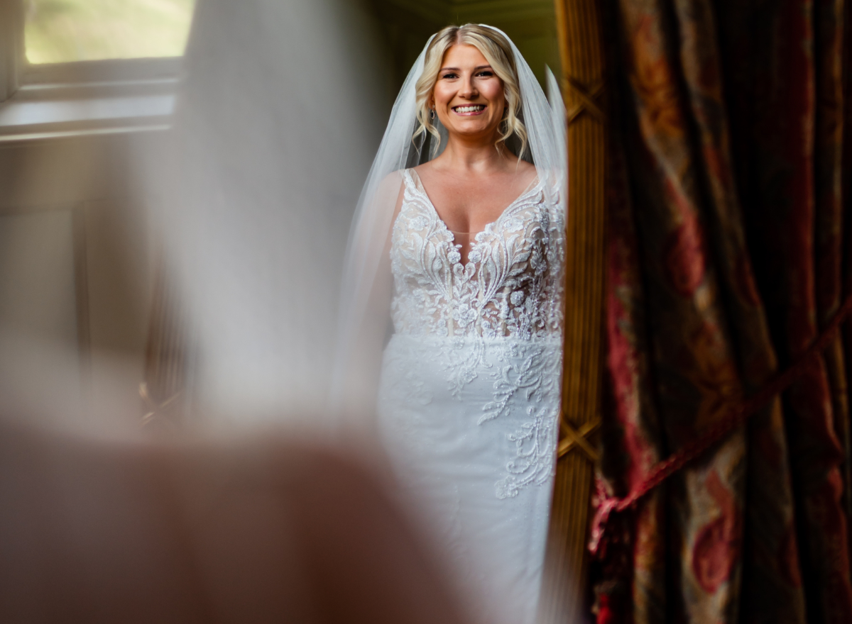 Bride smiling while looking in mirror
