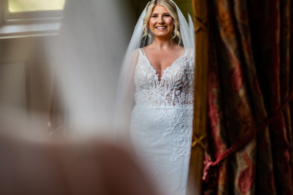 Bride smiling while looking in mirror