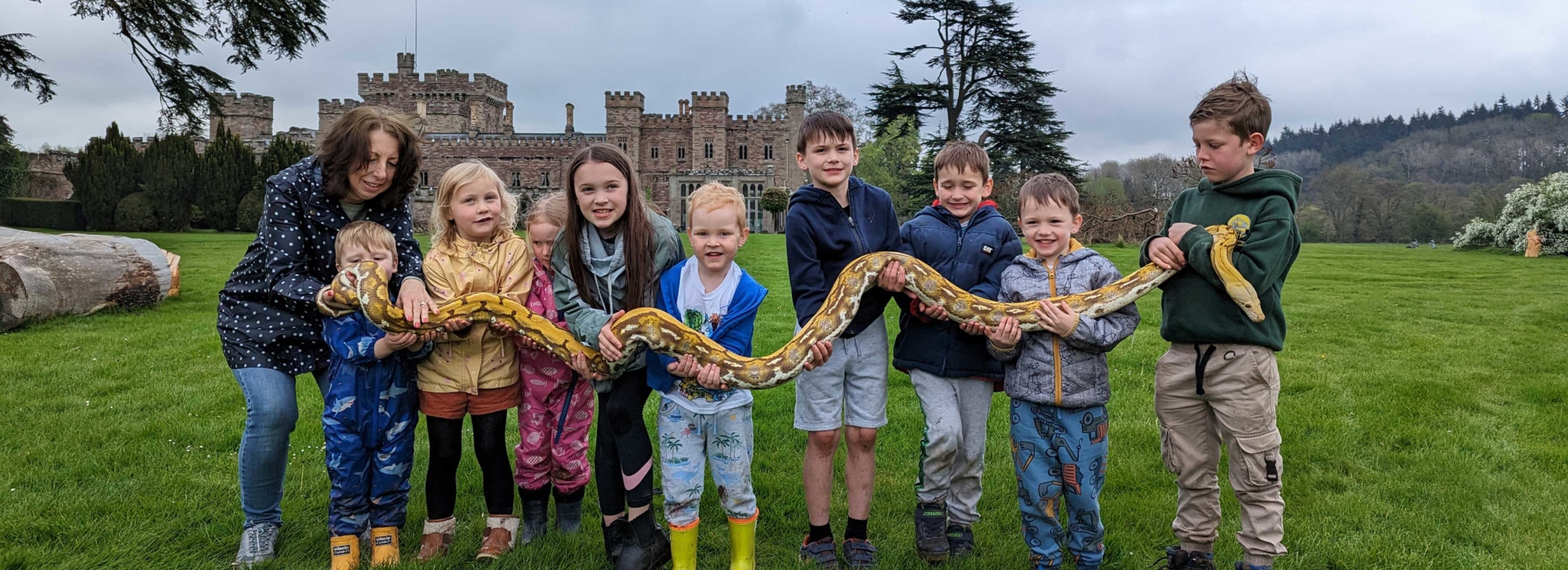 Children holding a snake during a fun day out at Herefordshire Castle