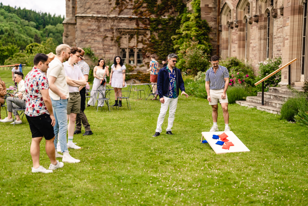 guests playing bean bag toss at Hampton Court Castle wedding