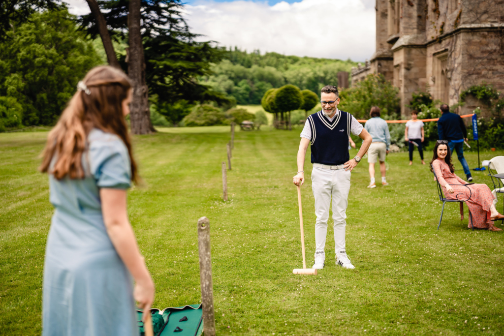 guests playing croquet at real wedding Hampton Court Castle