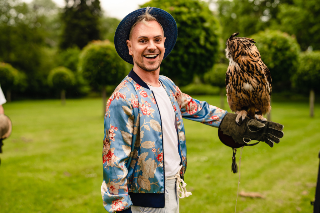 groom holding owl at wedding falconry experience
