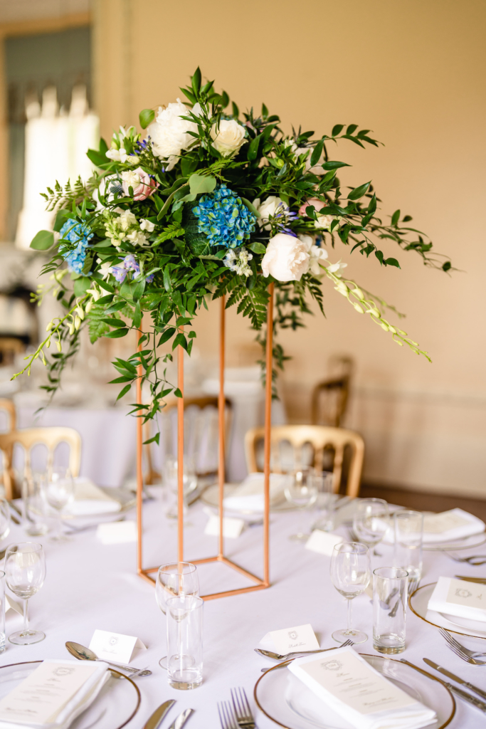 elevated floral display on wedding reception table